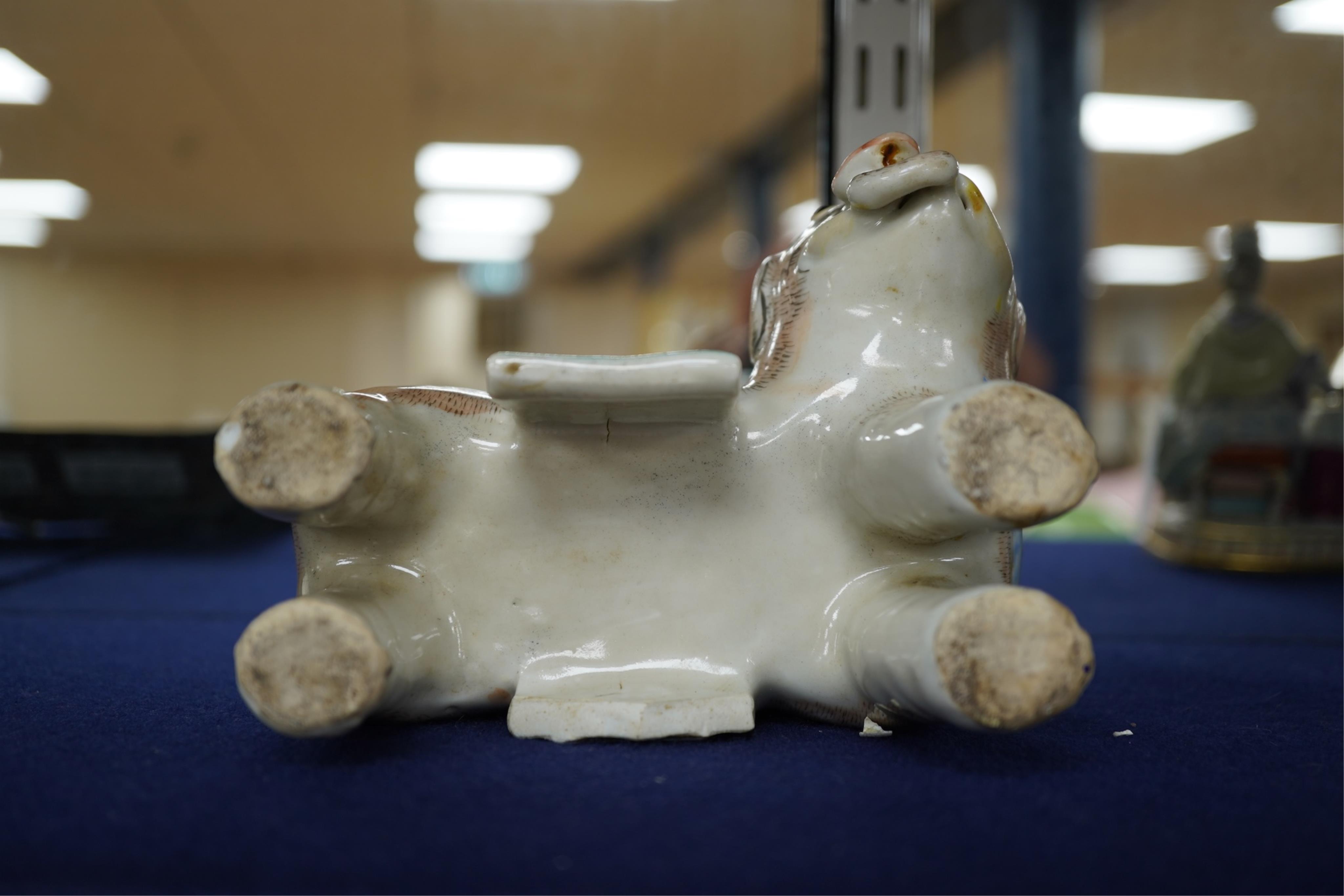 A 19th century Chinese enamelled porcelain vase in the form of an elephant with a howdah on its back